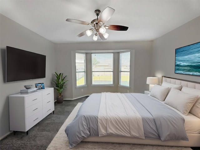 12223 Forstall Dr, Houston, TX 77014 - bedroom featuring baseboards, dark carpet, and ceiling fan