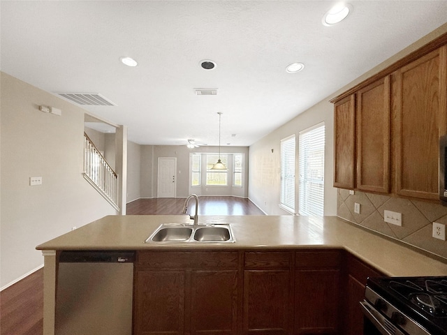 12223 Forstall Dr, Houston, TX 77014 - kitchen featuring a peninsula, visible vents, stainless steel appliances, and a sink