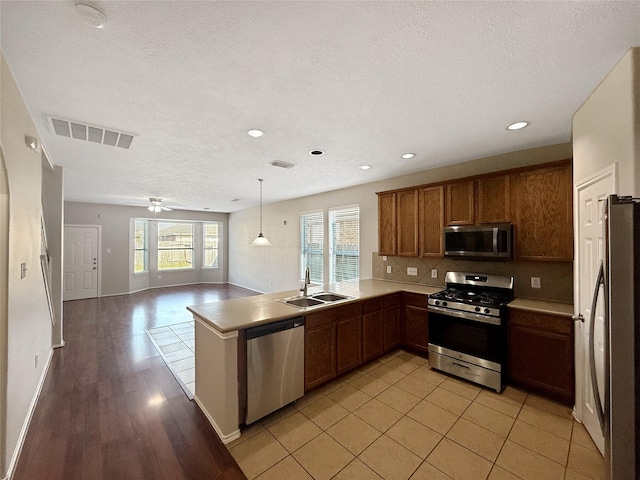 12223 Forstall Dr, Houston, TX 77014 - kitchen with stainless steel appliances, visible vents, a sink, tasteful backsplash, and open floor plan