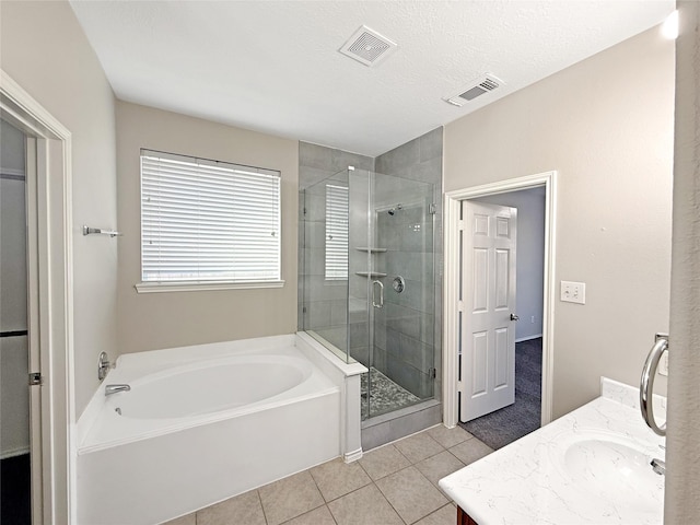 12223 Forstall Dr, Houston, TX 77014 - bathroom with tile patterned floors, a stall shower, visible vents, a garden tub, and vanity