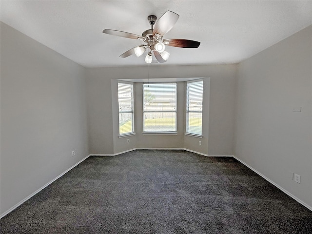 12223 Forstall Dr, Houston, TX 77014 - unfurnished room featuring dark colored carpet, a ceiling fan, and baseboards