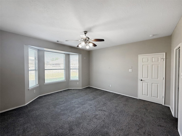 12223 Forstall Dr, Houston, TX 77014 - spare room with a textured ceiling, ceiling fan, dark carpet, baseboards, and visible vents