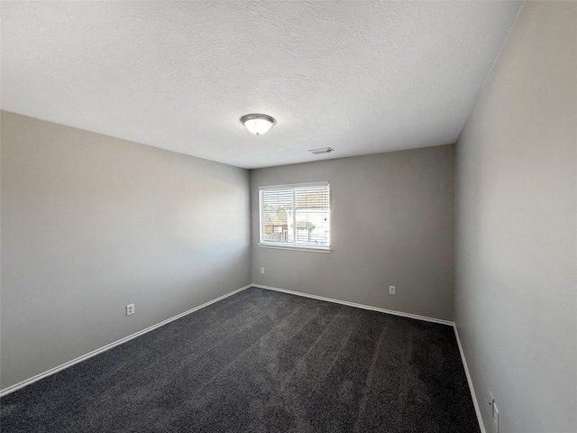12223 Forstall Dr, Houston, TX 77014 - empty room featuring baseboards, visible vents, dark carpet, and a textured ceiling