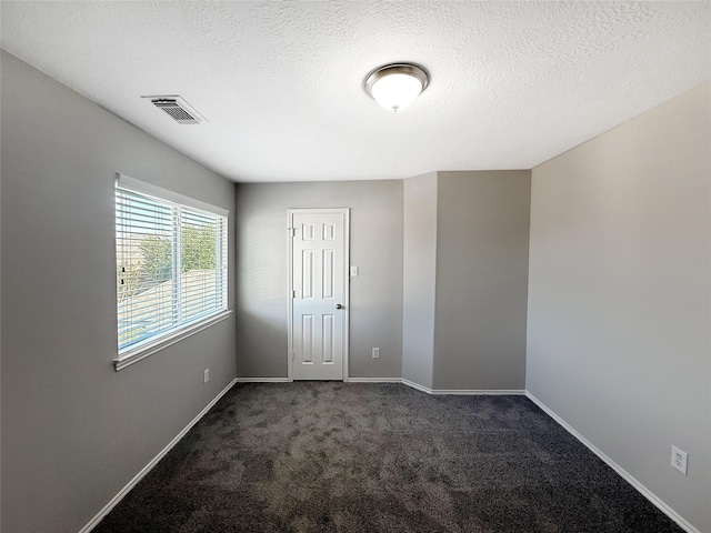 12223 Forstall Dr, Houston, TX 77014 - spare room with baseboards, visible vents, carpet, and a textured ceiling
