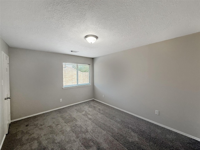 12223 Forstall Dr, Houston, TX 77014 - spare room with dark colored carpet, a textured ceiling, baseboards, and visible vents