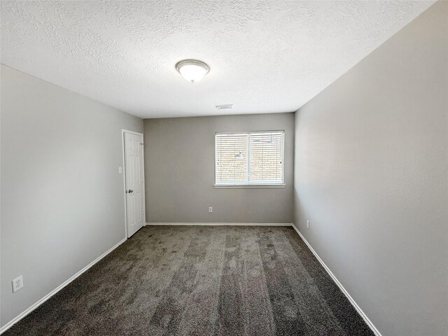 12223 Forstall Dr, Houston, TX 77014 - empty room with carpet floors, a textured ceiling, and baseboards