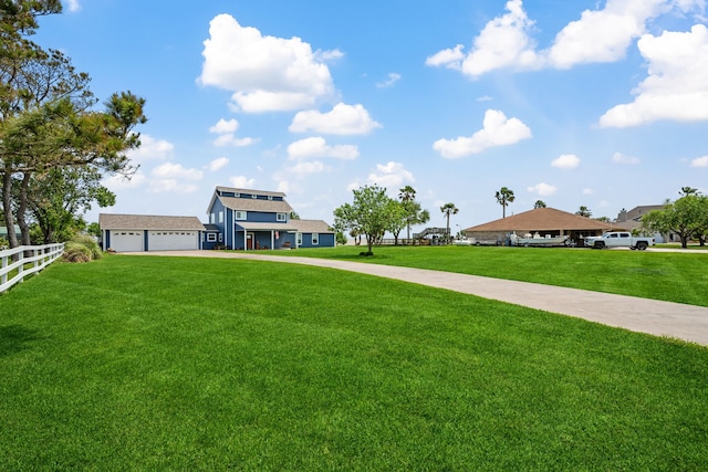 exterior space featuring fence, a yard, and driveway