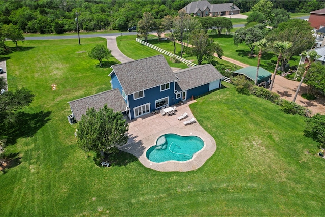 pool with a lawn and a patio