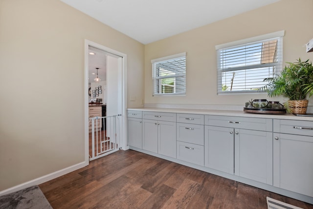 interior space with baseboards and wood finished floors