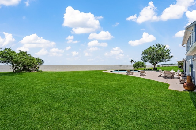 view of yard with an outdoor pool, a patio area, and a water view