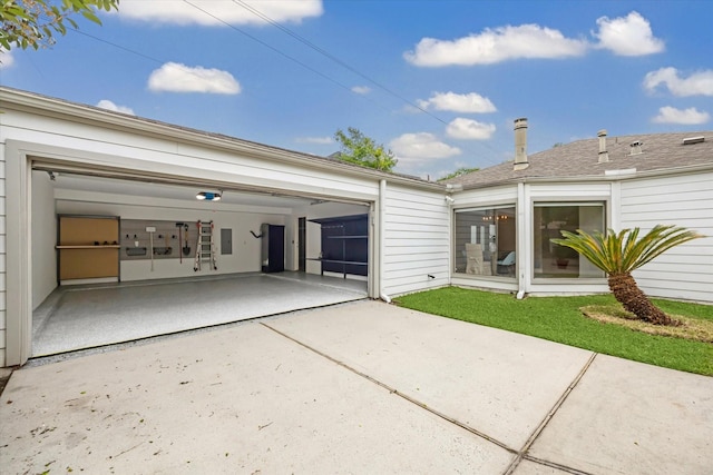 back of house featuring concrete driveway
