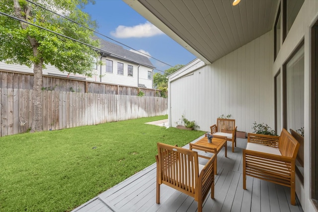 exterior space with a deck, an outdoor hangout area, and fence private yard