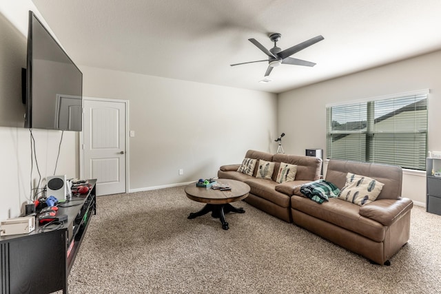 carpeted living room featuring a ceiling fan and baseboards