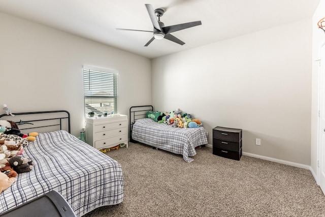 carpeted bedroom with a ceiling fan and baseboards