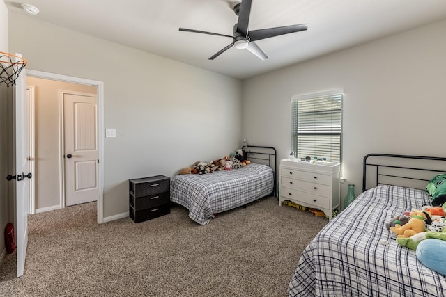 carpeted bedroom featuring baseboards and a ceiling fan
