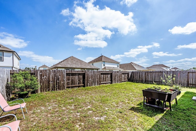 view of yard featuring a fenced backyard and a vegetable garden