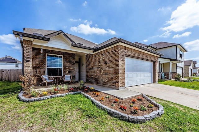 ranch-style home with an attached garage, fence, brick siding, and a front yard