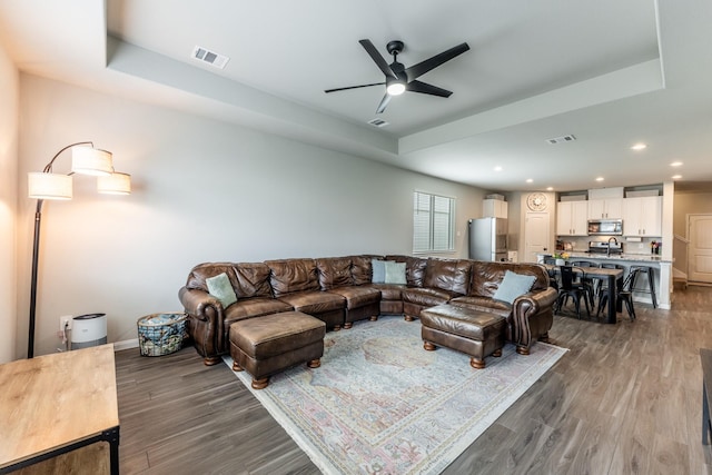 living area featuring wood finished floors, visible vents, recessed lighting, and a ceiling fan