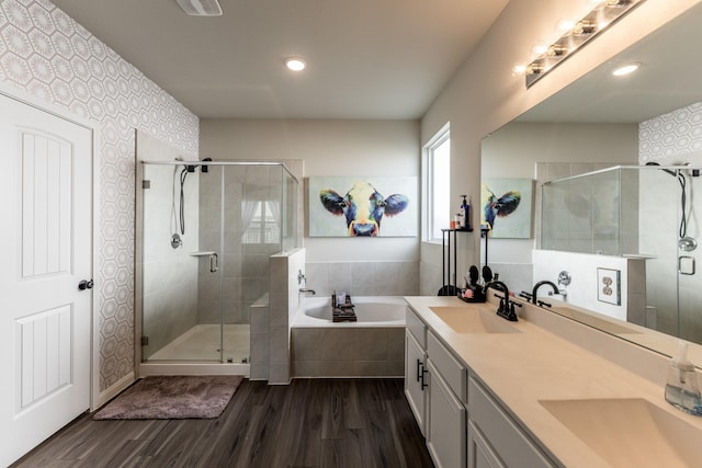 bathroom with wood finished floors, a sink, and a stall shower