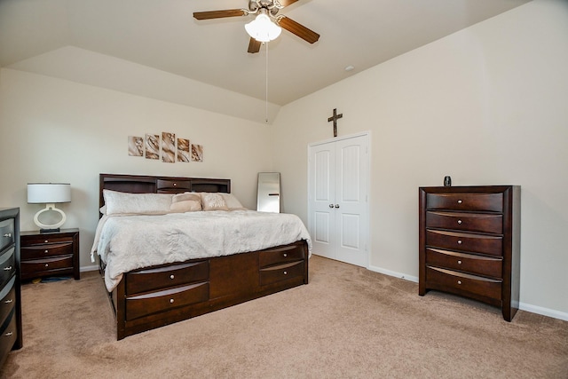 bedroom with vaulted ceiling, baseboards, and light carpet