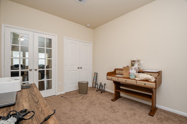 living area featuring baseboards, french doors, and carpet