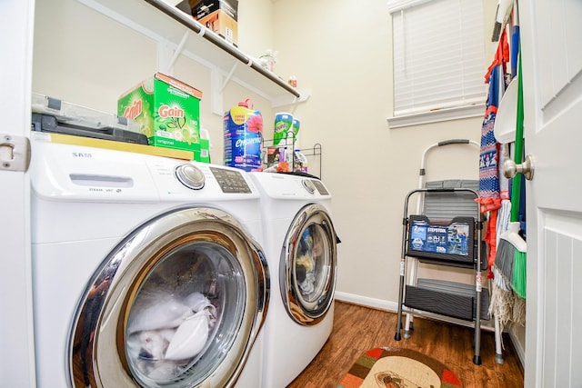 laundry room with separate washer and dryer, baseboards, wood finished floors, and laundry area