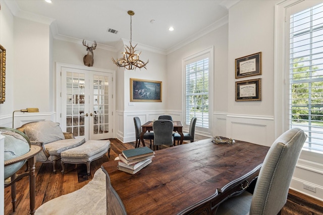 home office with french doors, dark wood-style flooring, healthy amount of natural light, ornamental molding, and wainscoting