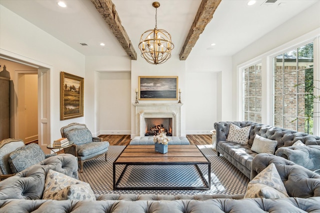 living area with a chandelier, wood finished floors, beamed ceiling, baseboards, and recessed lighting