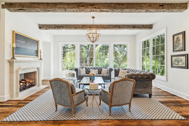 living room with baseboards, wood finished floors, beamed ceiling, and a fireplace with flush hearth