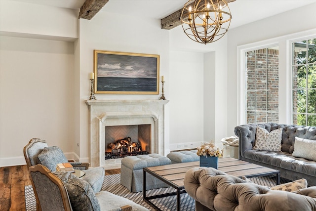 living room with wood finished floors, a chandelier, plenty of natural light, a high end fireplace, and beam ceiling