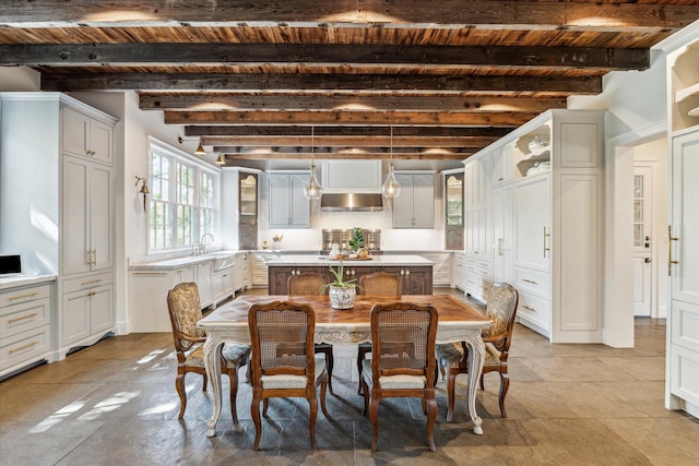 dining room with wood ceiling and beamed ceiling