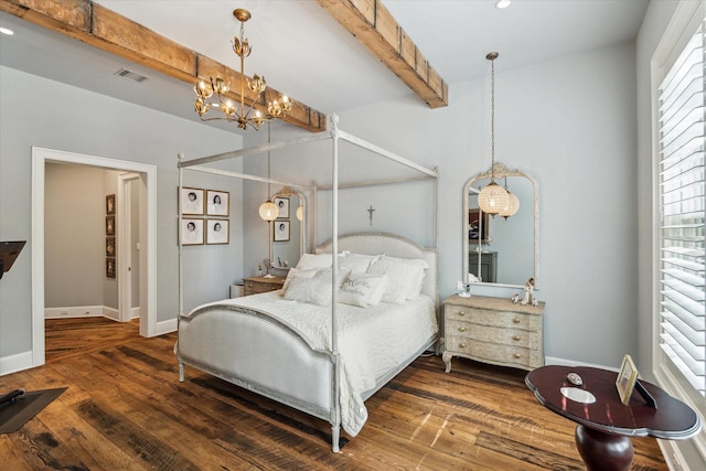 bedroom featuring a chandelier, beam ceiling, wood finished floors, and baseboards