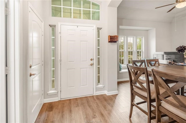 entrance foyer featuring light wood-style floors, baseboards, and ceiling fan