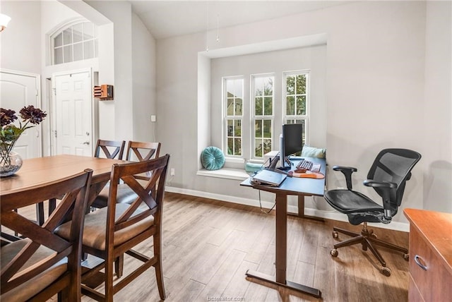 dining area with wood finished floors and baseboards