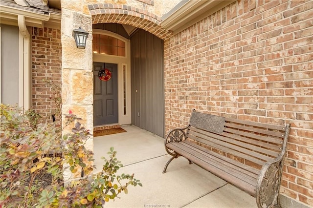 doorway to property featuring brick siding
