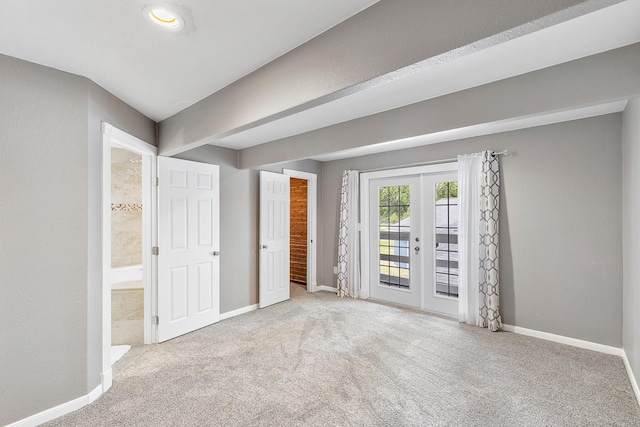 unfurnished bedroom with baseboards, access to outside, french doors, and carpet