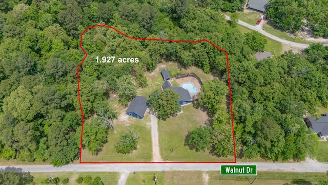 drone / aerial view with a wooded view