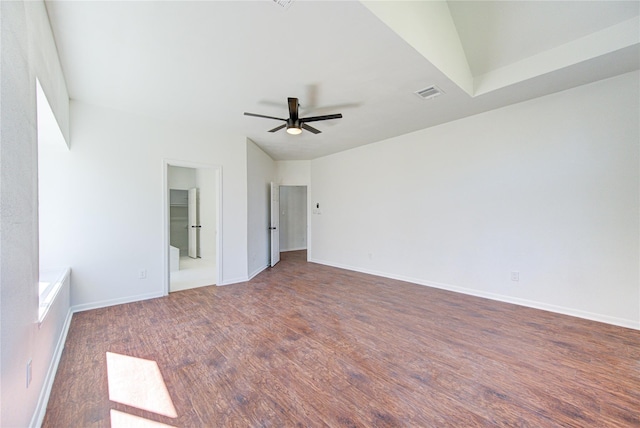 unfurnished bedroom featuring wood finished floors, visible vents, a ceiling fan, baseboards, and ensuite bathroom