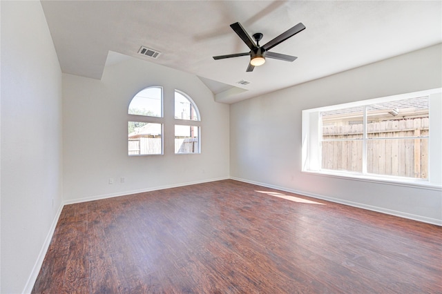 unfurnished room featuring baseboards, visible vents, lofted ceiling, a ceiling fan, and wood finished floors