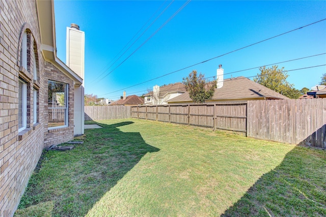 view of yard with a fenced backyard