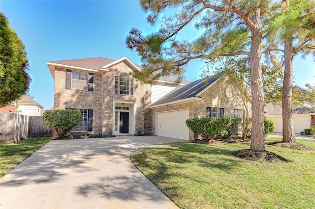 view of front of property with fence, driveway, brick siding, a front yard, and a garage