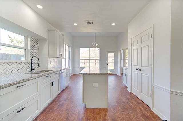 kitchen featuring plenty of natural light, visible vents, a sink, and a notable chandelier