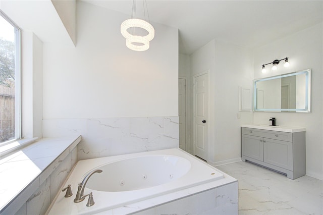 full bath with vanity, marble finish floor, a tub with jets, and an inviting chandelier
