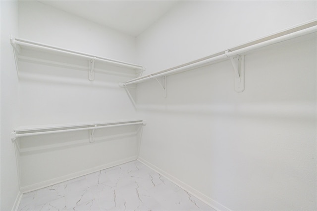 spacious closet featuring marble finish floor