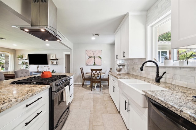 kitchen featuring black range with gas cooktop, island range hood, decorative backsplash, dishwashing machine, and visible vents