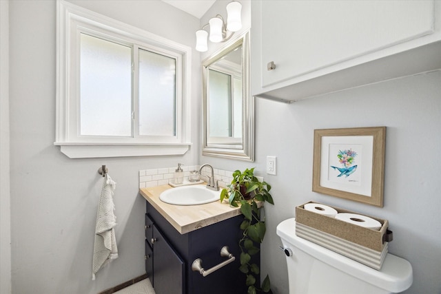 bathroom featuring toilet and vanity