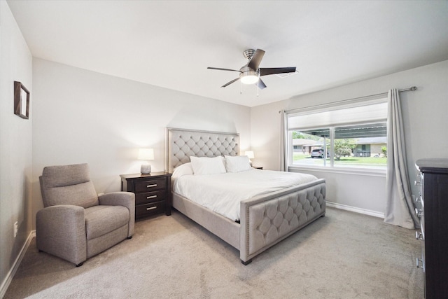 bedroom with baseboards, a ceiling fan, and light colored carpet