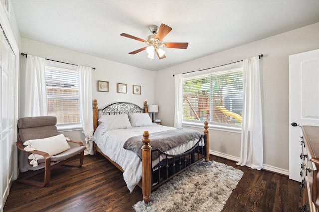 bedroom featuring baseboards, wood finished floors, and ceiling fan