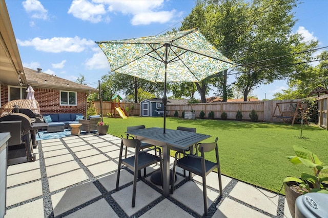view of patio / terrace with an outdoor living space, a fenced backyard, outdoor dining space, and a shed