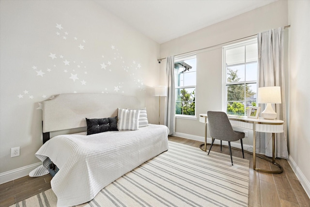 bedroom featuring wood finished floors and baseboards